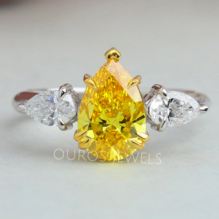front view of yellow pear cut lab diamond three stone engagement ring