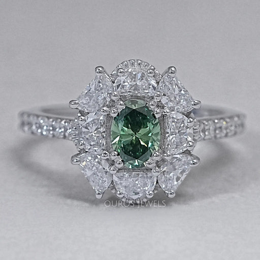 front view of green oval cut diamond half moon halo engagement ring