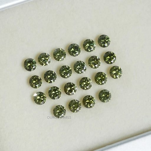 side view of round lab grown green diamonds loose