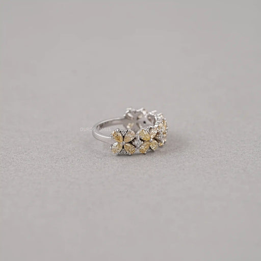 right side view of floral shape yellow pear-cut lab diamond colored engagement ring