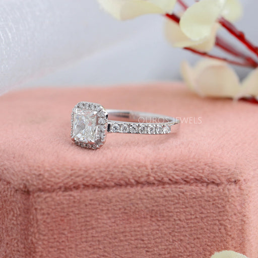 side view of radiant cut diamond solitaire halo wedding band on jewelry box