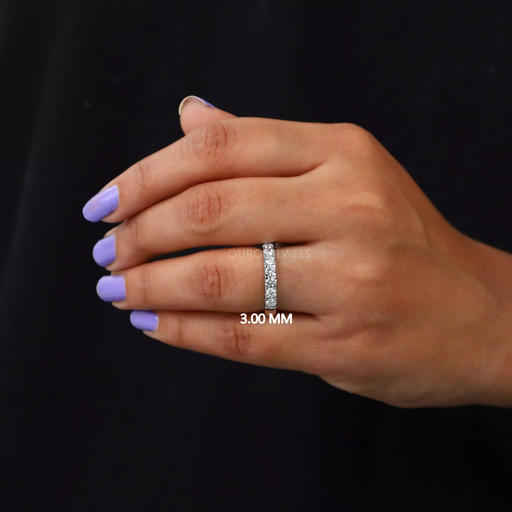 round shape man made diamond half white gold eternity wedding band in finger