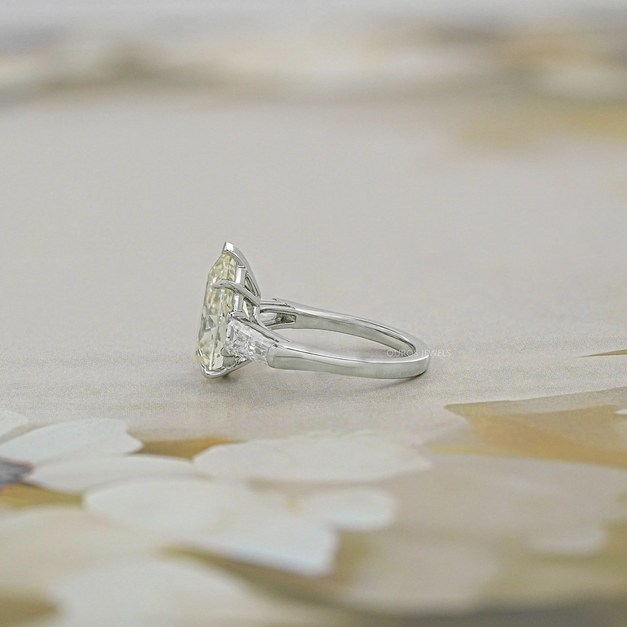 Pear Cut Three Stone Engagement Ring with Tapered Baguettes