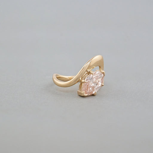 side view of pink marquise cut diamond bypass engagement ring yellow gold band