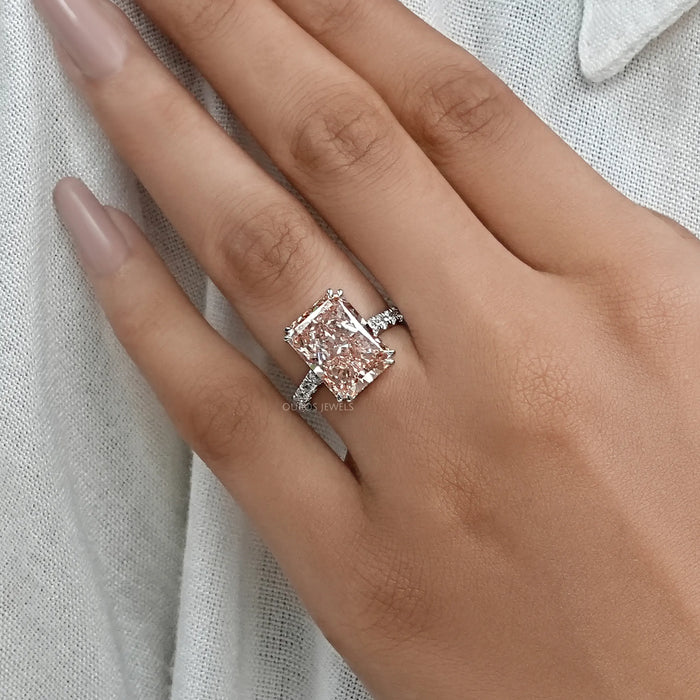 pink radiant-cut diamond double-prong solitaire engagement ring on model's finger