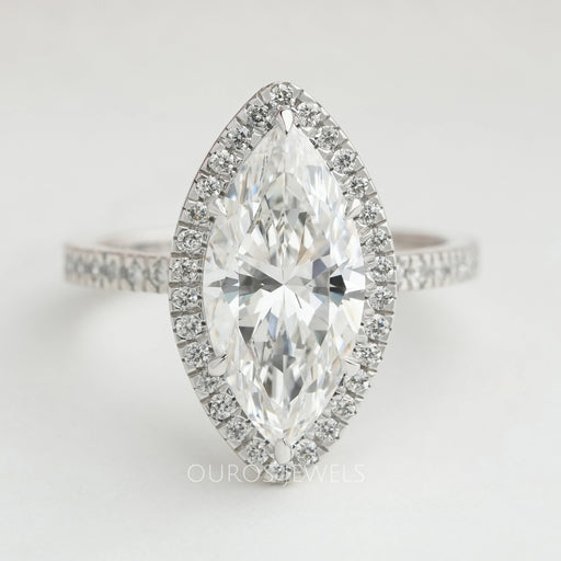 front view of marquise cut lab diamond halo engagement ring on grey fabric