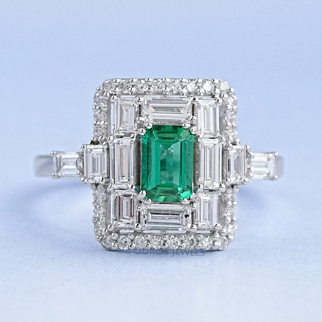 top view of green emerald baguette & round diamond halo gemstone engagement ring