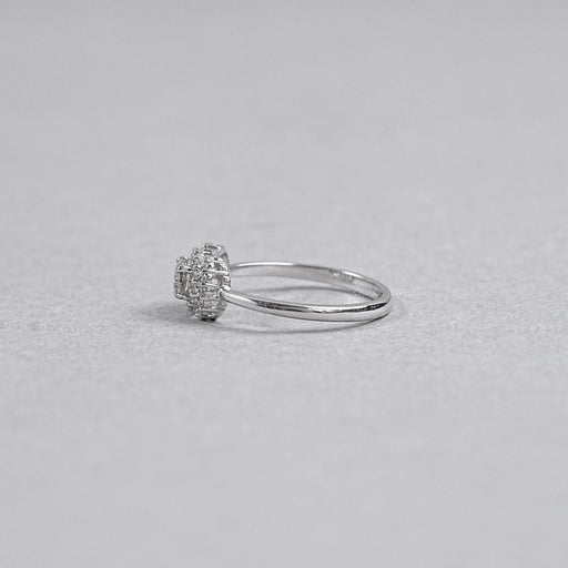 olive oval diamond halo engagement ring's side angle on grey background