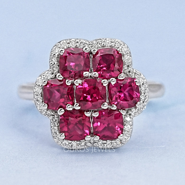 top view of red ruby cushion cut & round diamond floral halo engagement ring