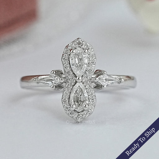 front view of step cut pear shaped diamonds side stone engagement ring