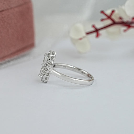 side view of two step cut pear shaped diamonds side stone halo engagement ring