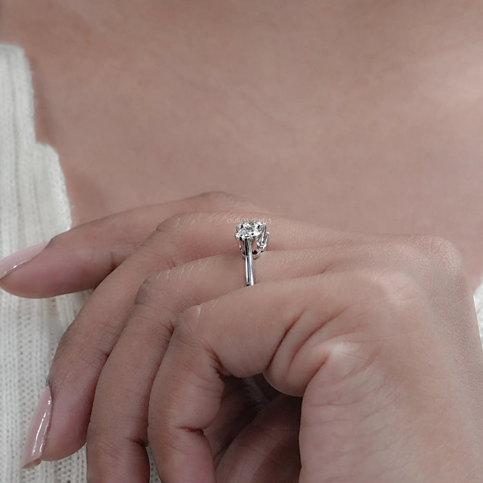 old european round cut lab diamond three stone engagement ring on model's finger