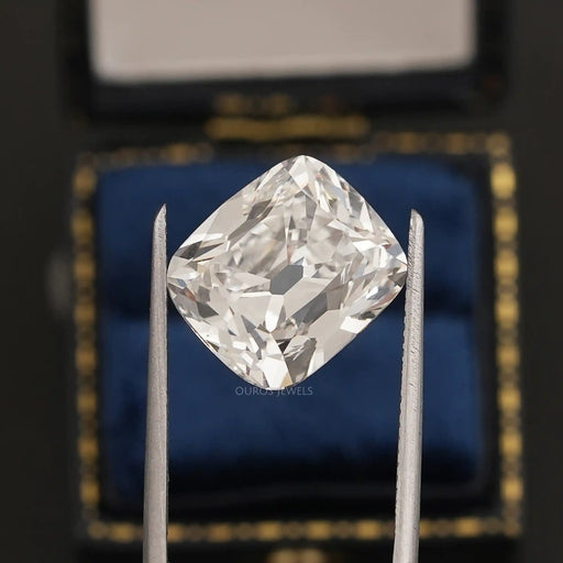 10 carat igi certified old mine cushion cut lab grown diamond held by tweezer