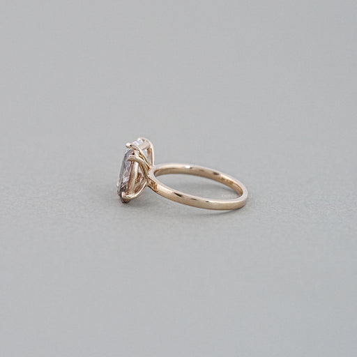 side view of emerald and champagne oval-cut diamond toi et moi engagement ring