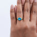 east west blue oval cut gemstone wedding ring on model's hand