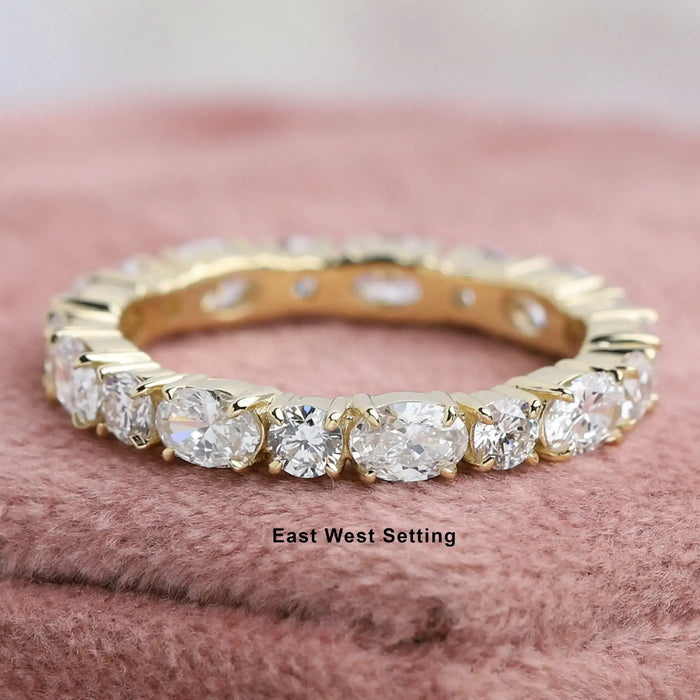 front view of oval and round lab grown diamond eternity wedding band yellow gold