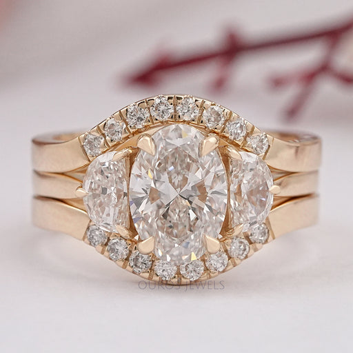 front view of oval-cut lab diamond solitaire bridal ring set with yellow gold band