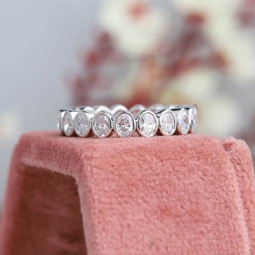 front view of oval cut lab grown diamond bezel set eternity band white gold