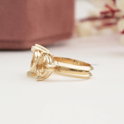 side view of oval-shaped semi-mount three-stone engagement ring