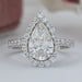 pear cut diamond solitaire halo engagement ring's front view on grey fabric