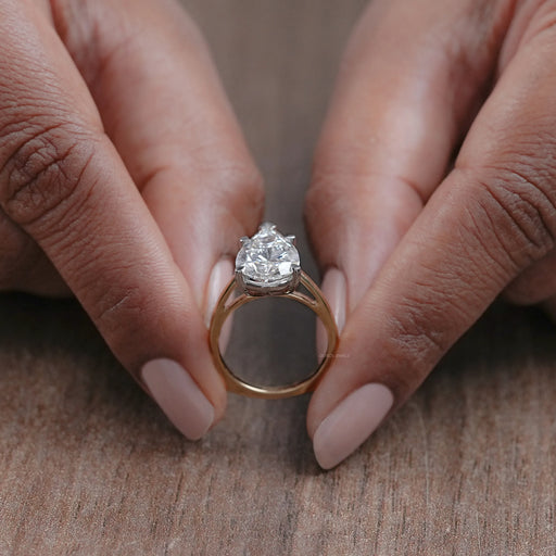 close up view of pear shaped lab diamond solitaire 5 prong engagement ring
