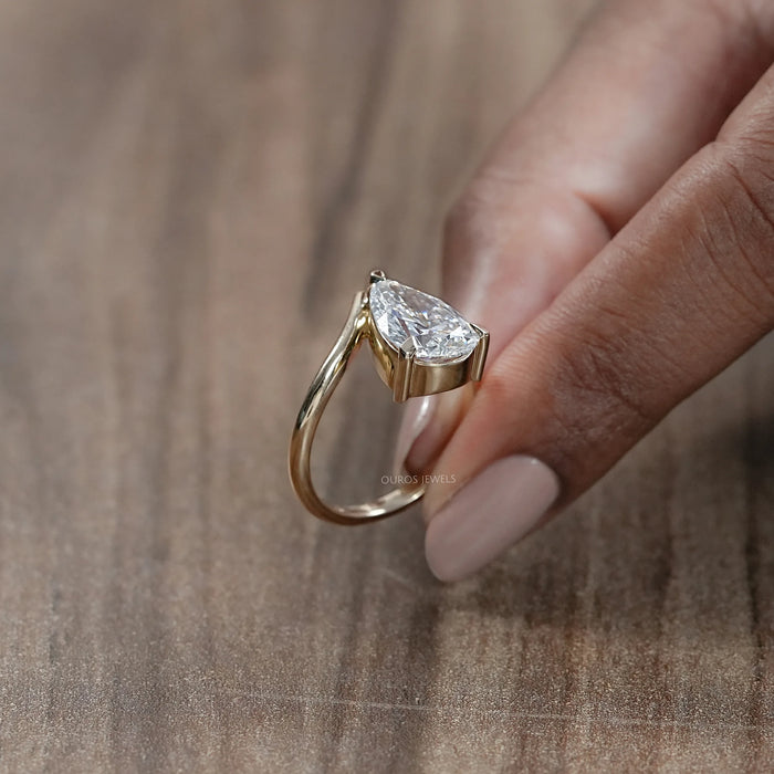 side view of v shape pear cut lab diamond solitaire engagement ring