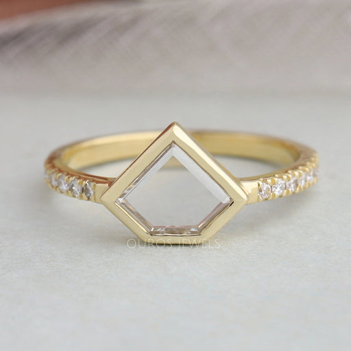 pentagon portrait cut diamond bezel set engagement ring's front view on grey fabric