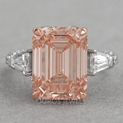 front view of pink emerald diamond three-stone hidden halo colored engagement ring