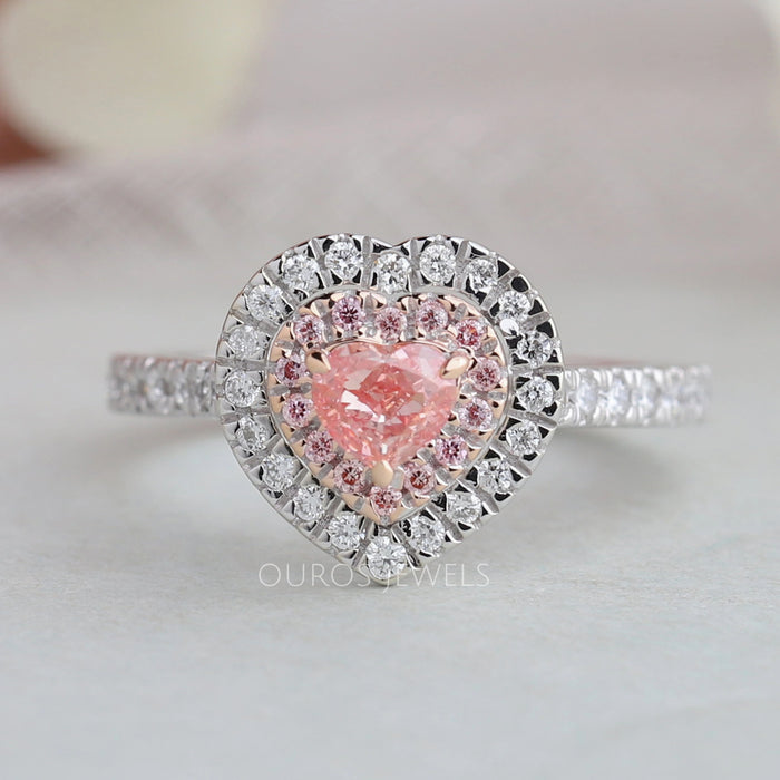 pink heart cut diamond double halo engagement ring's front view on grey fabric