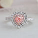 pink heart cut diamond double halo engagement ring's front view on grey fabric