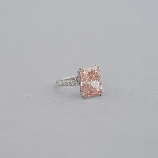 side view of pink radiant-cut diamond double-prong solitaire accent engagement ring