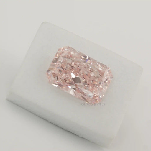 pink radiant cut lab created diamond loose gemstone on white fabric