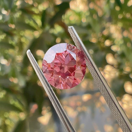 2.50 carat pink loose old european cut diamond lab grown held with tweezer