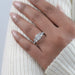 radiant cut diamond five stone engagement ring with white gold band on model's finger