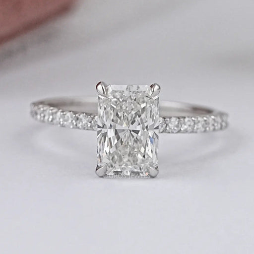 front view of radiant-cut lab diamond solitaire accent engagement ring on grey fabric