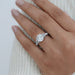 trapezoid and round shape five stone diamond ring on model's finger