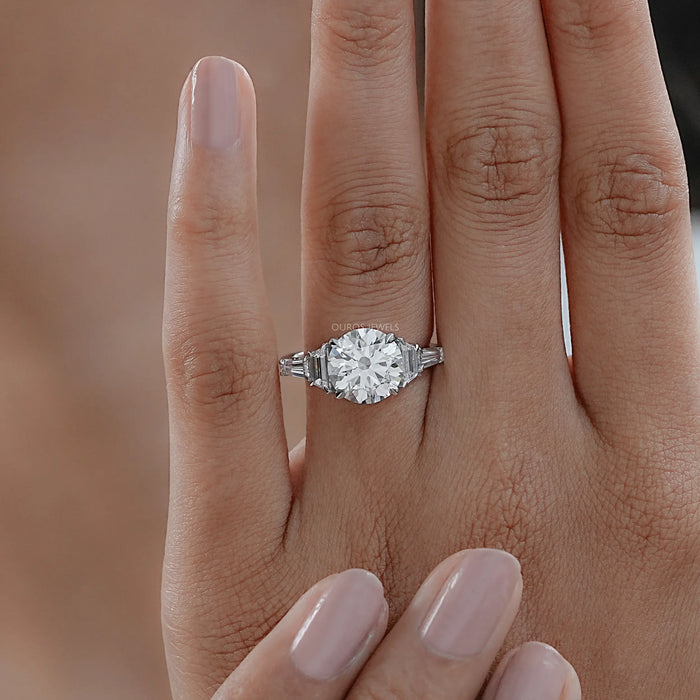 trapezoid and round shape five stone diamond engagement ring in finger