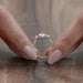 close view of three stone pear cut diamond hidden halo engagement ring