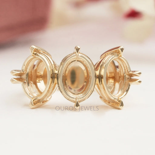 front view of oval-shaped semi-mount three-stone engagement ring