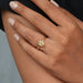 yellow oval cut lab diamond solitaire engagement ring in model's finger