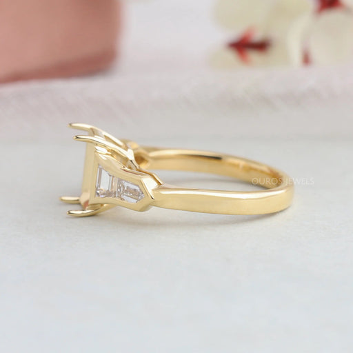 side view of bullet diamond and trapezoid-cut semi-mount engagement ring on fabric