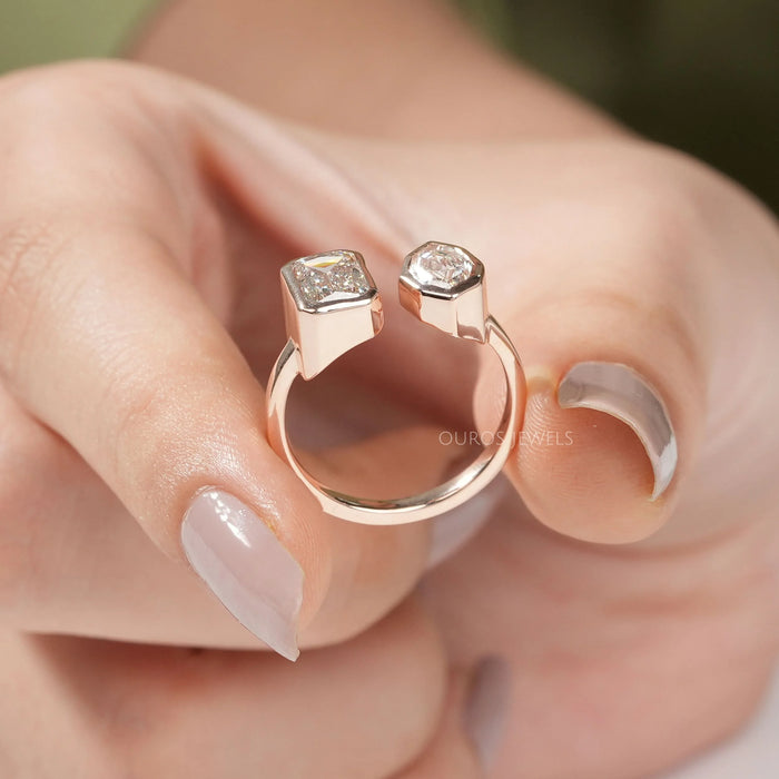 close view of criss cut and step moval diamond bezel set toi et moi wedding ring