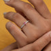 front view of pink kite-cut lab diamond solitaire accent wedding ring in finger