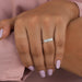 emerald cut lab grown diamond five stone wedding band on model's finger