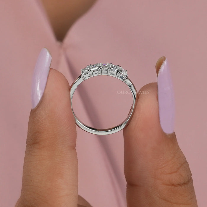 close view of emerald cut lab grown diamond five stone wedding band