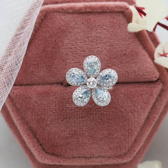 A close up look of 1.50 CTW blue pear cut lab diamond halo engagement ring