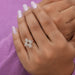 In finger look of pear shaped halo diamond ring with flower shaped design and a split shank