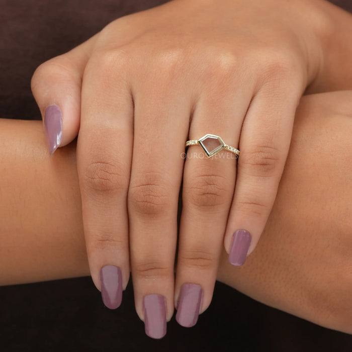 pentagon portrait cut lab diamond bezel set engagement ring in finger