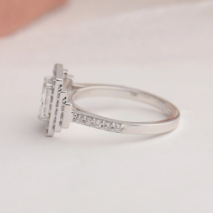 Round accent stones studded on 14k white gold shank of radiant cut lab diamond engagement ring