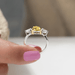 close view of yellow pear cut lab diamond three stone engagement ring